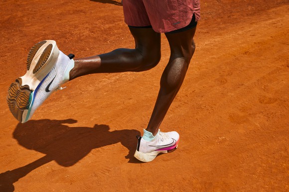 Man running in Nike sneakers.