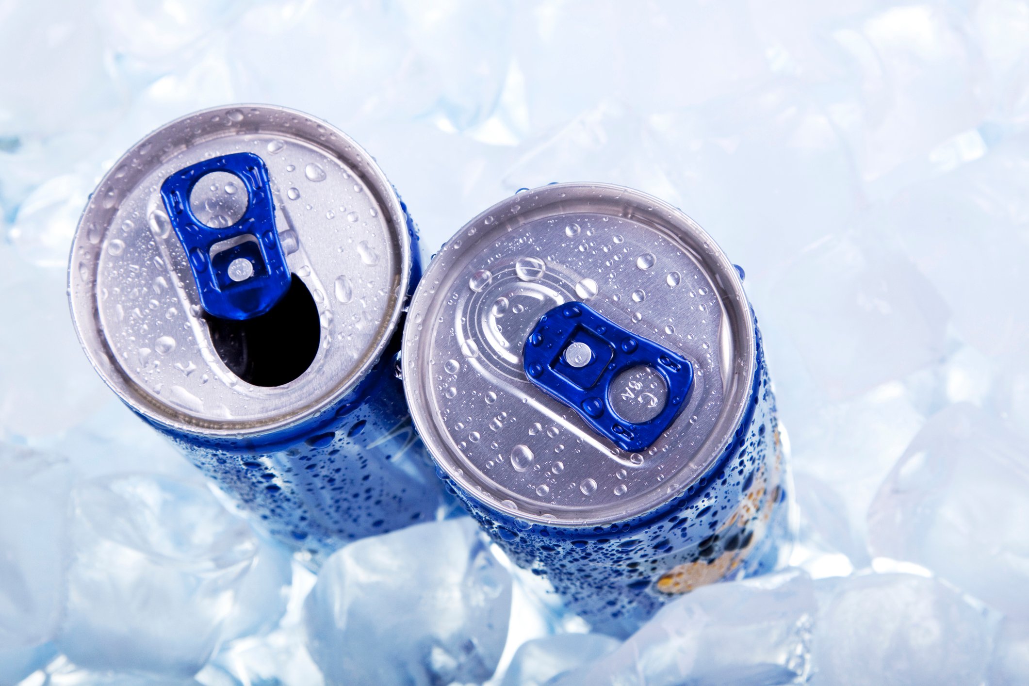 Two canned drinks in ice, with one pop-top opened