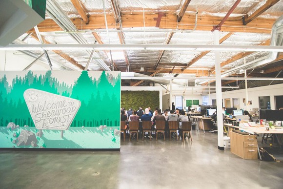 Robinhood headquarters with people seated around a conference table in the background.