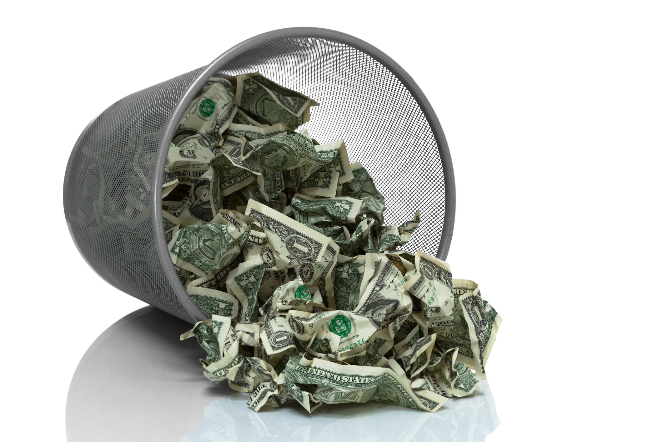 Pile of money in an overturned trashcan. 