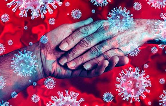Coronaviruses imposed over a pair of elderly hands.