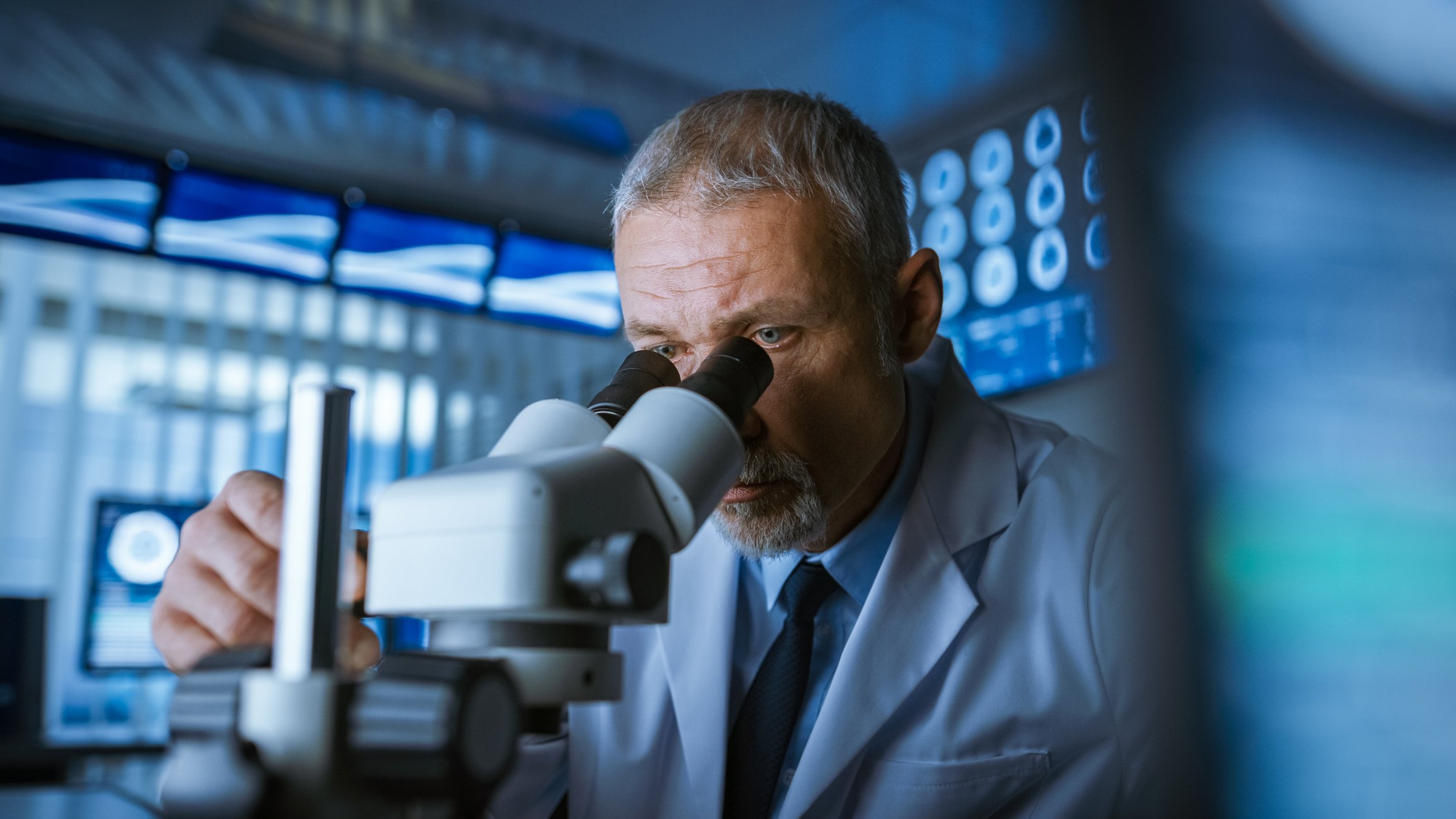 Scientist looking through microscope