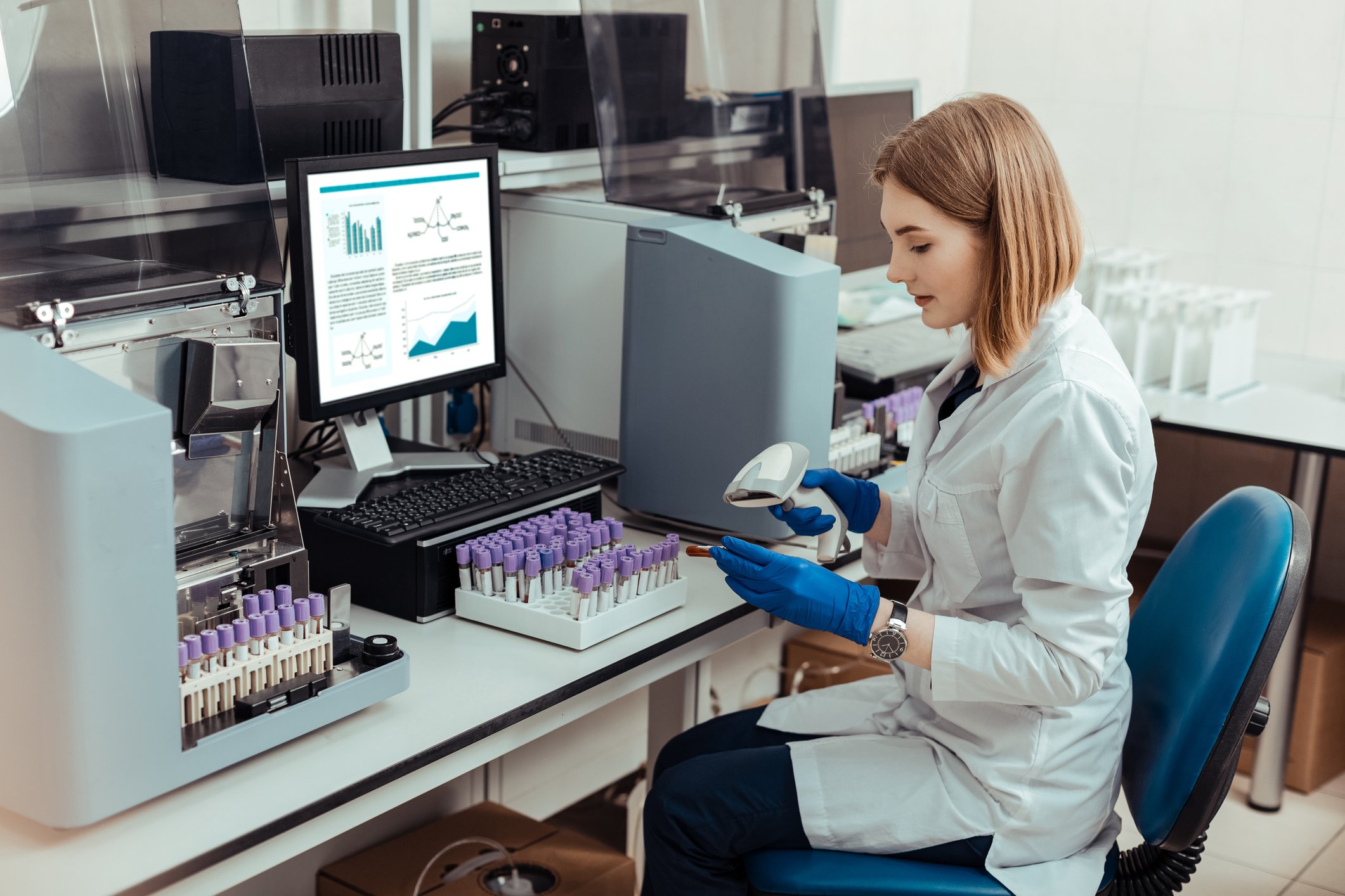 woman in lab working with barcode scanner and vials