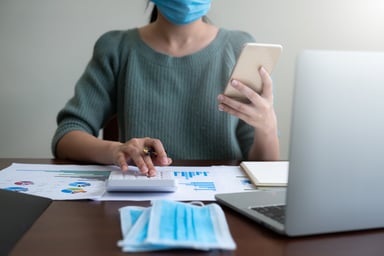 Woman wearing mask with calculator