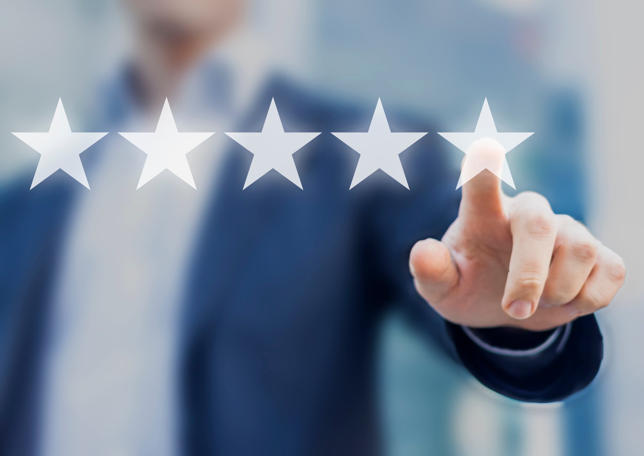 Businessman pointing to one of five stars