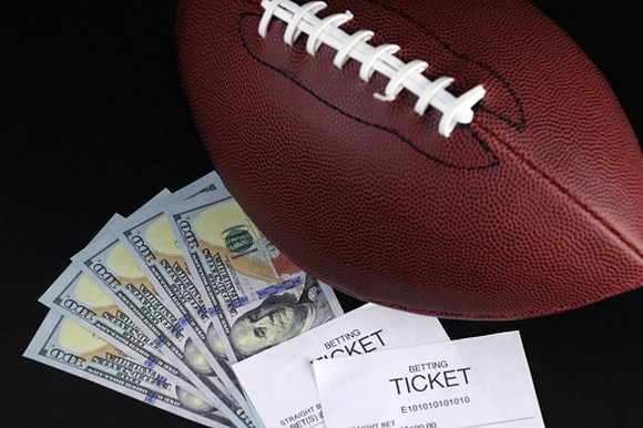 5, $100 bills, a football and 2 betting receipts