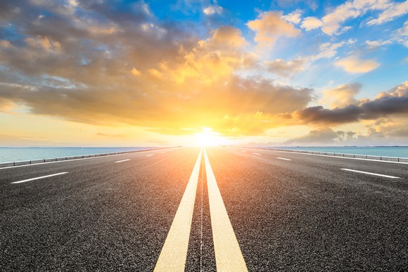 View down a roadway into a bright horizon. 