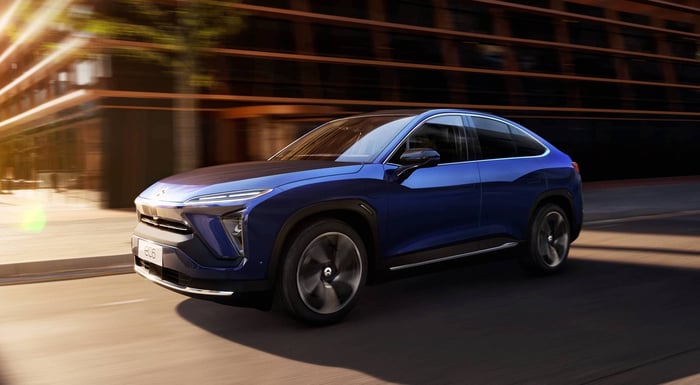 A blue NIO EC6, an upscale electric five-passenger SUV with a sleek coupe-like roofline.