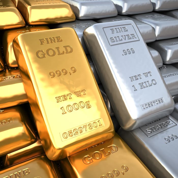 Gold and silver bars sitting side by side.