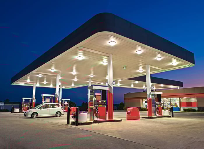 A gas station and convenience store at night.