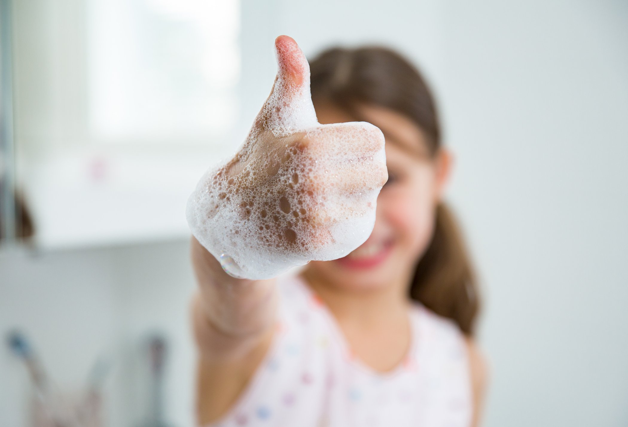 Girl with soap on her hands.
