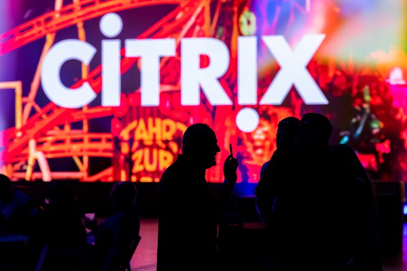 Silhouettes of people in front of the Citrix logo
