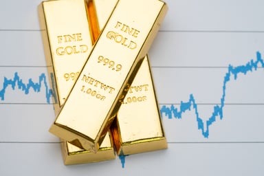 Gold bars with stock chart in the background