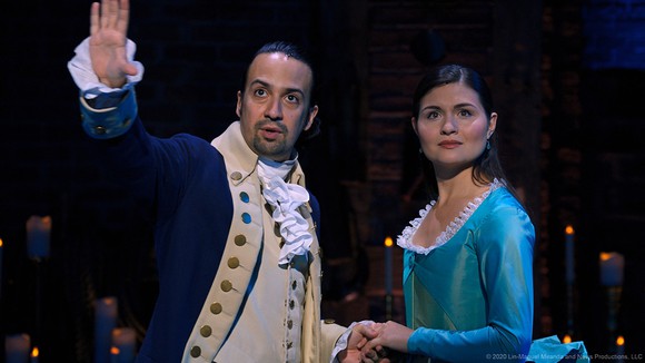 A still of the Broadway recording of Hamilton, with characters Hamilton and Eliza looking out into the distance.