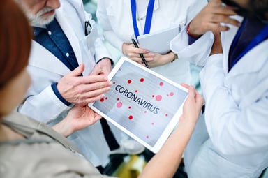 Scientists with tablet displaying coronavirus