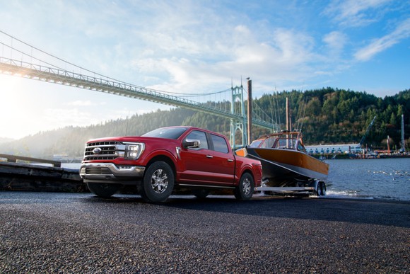 A 2021 Ford F-150 pulling a boat on a trailer. 
