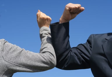 Two people bumping elbows