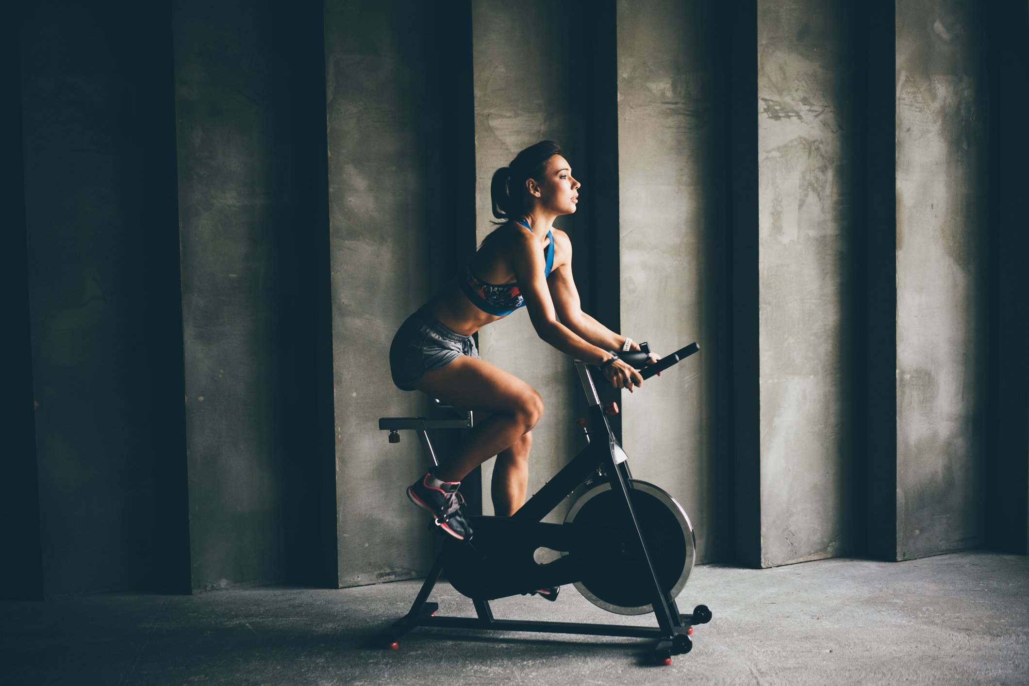 A woman exercising on a Peloton machine.
