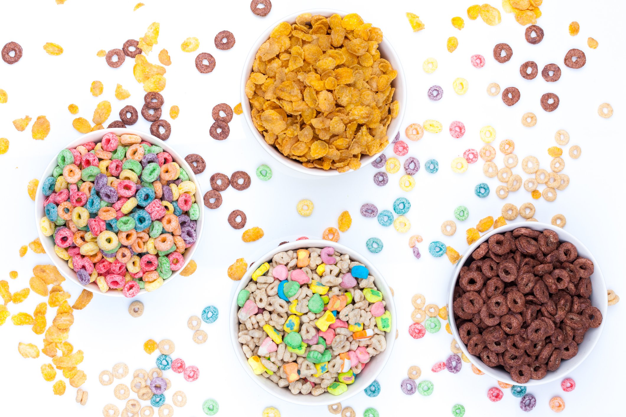 overhead view of four bowls of kids cereals