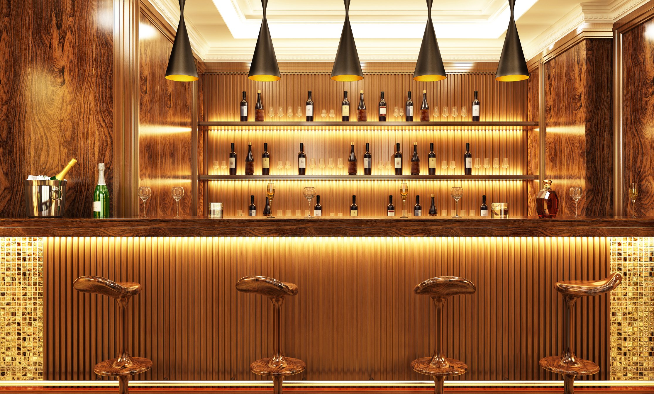 An empty bar with stools in front and bottles behind it.