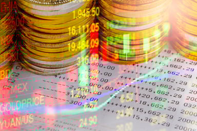 Stacks of gold coins on financial charts