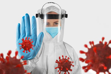 Female scientist holding hand up to coronavirus