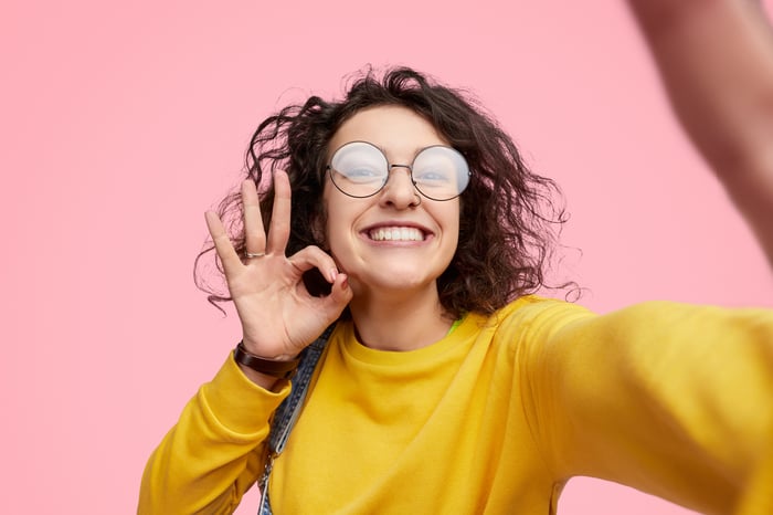 A young woman takes a selfie.