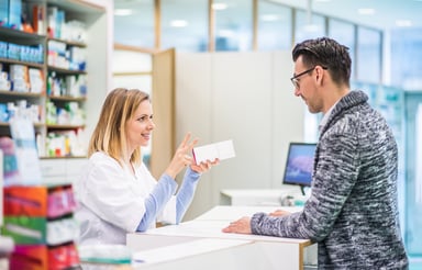 woman pharmacist speaking with client