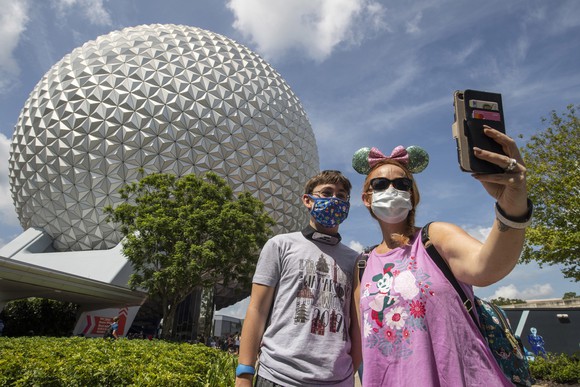 Visitors in masks at Epcot Center in Disney World.