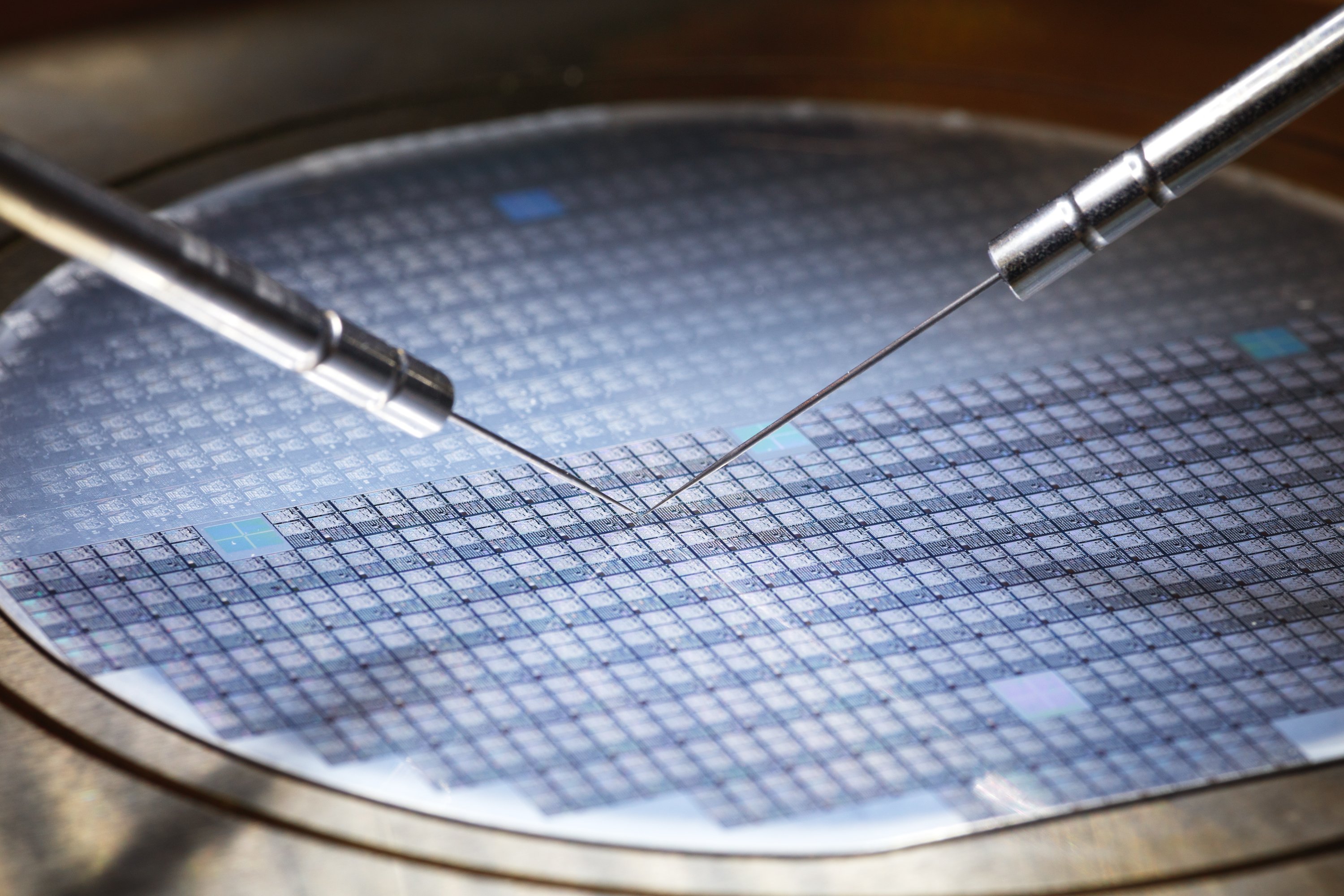 Closeup of a semiconductor equipment machine making a chip on a circular wafer. 