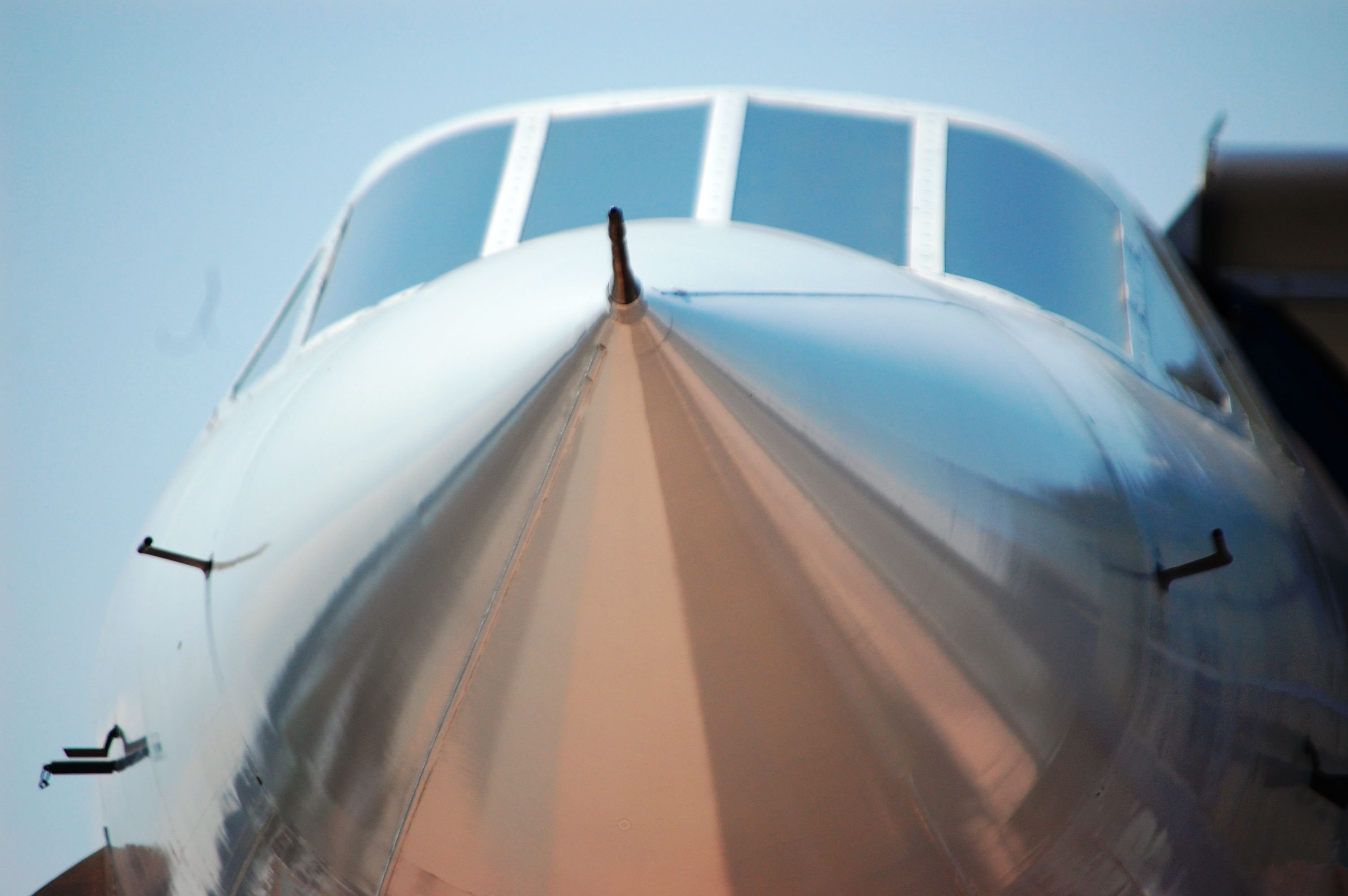A blurred close-up view of the nose of a Concorde supersonic jet