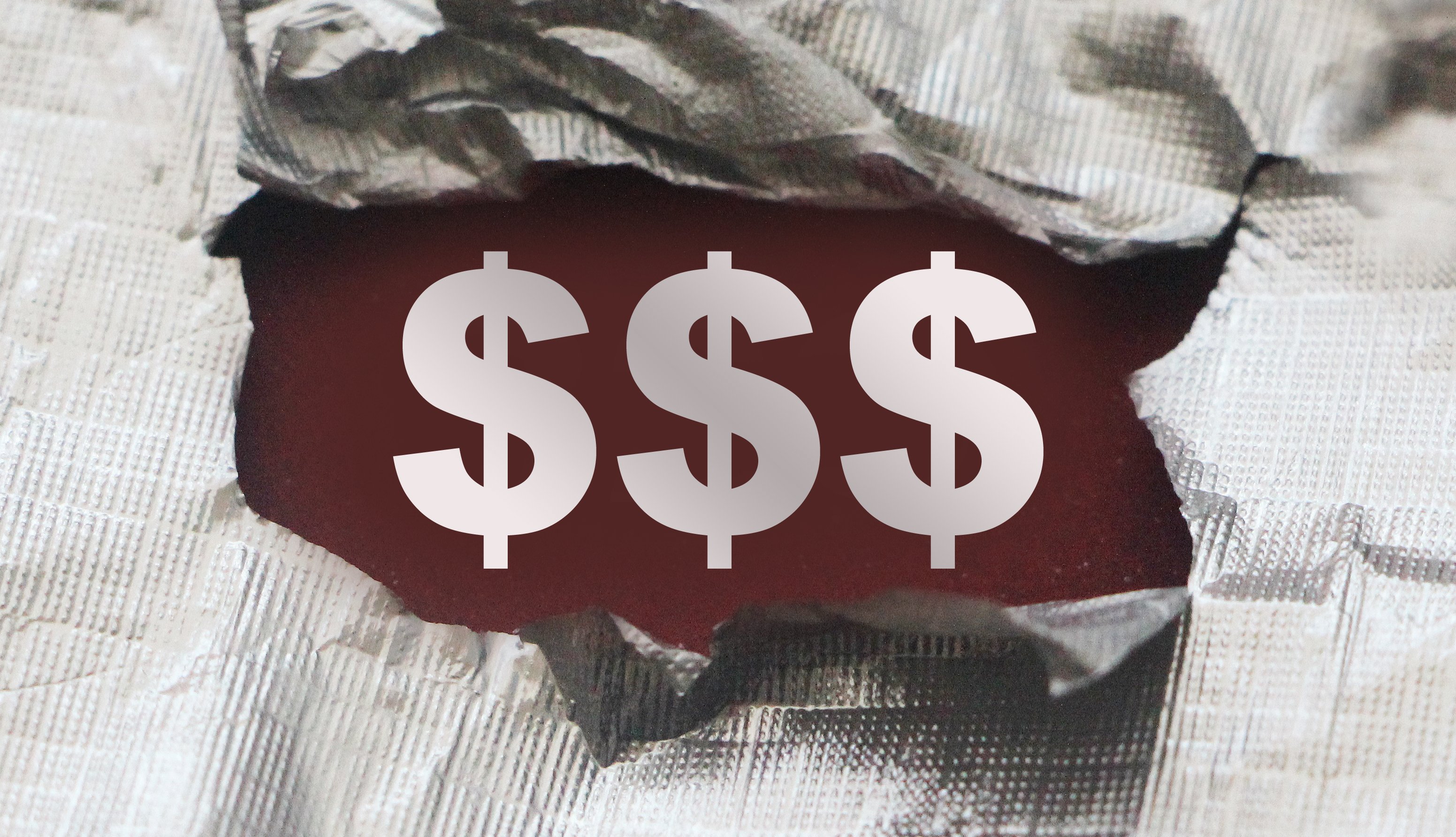 Three dollar signs made visible by a tear in a piece of fabric