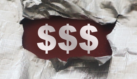 Three dollar signs made visible by a tear in a piece of fabric