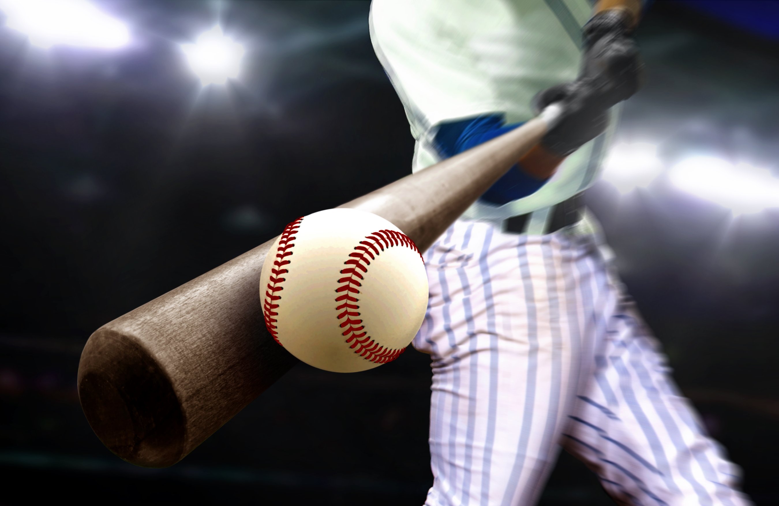 A baseball player hitting a ball.