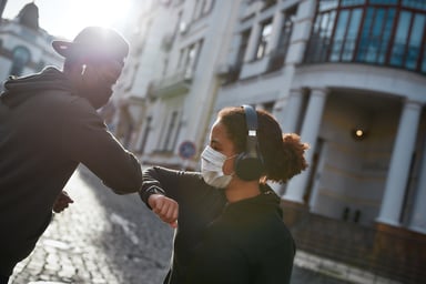 A young couple exercise bump elbows wear masks