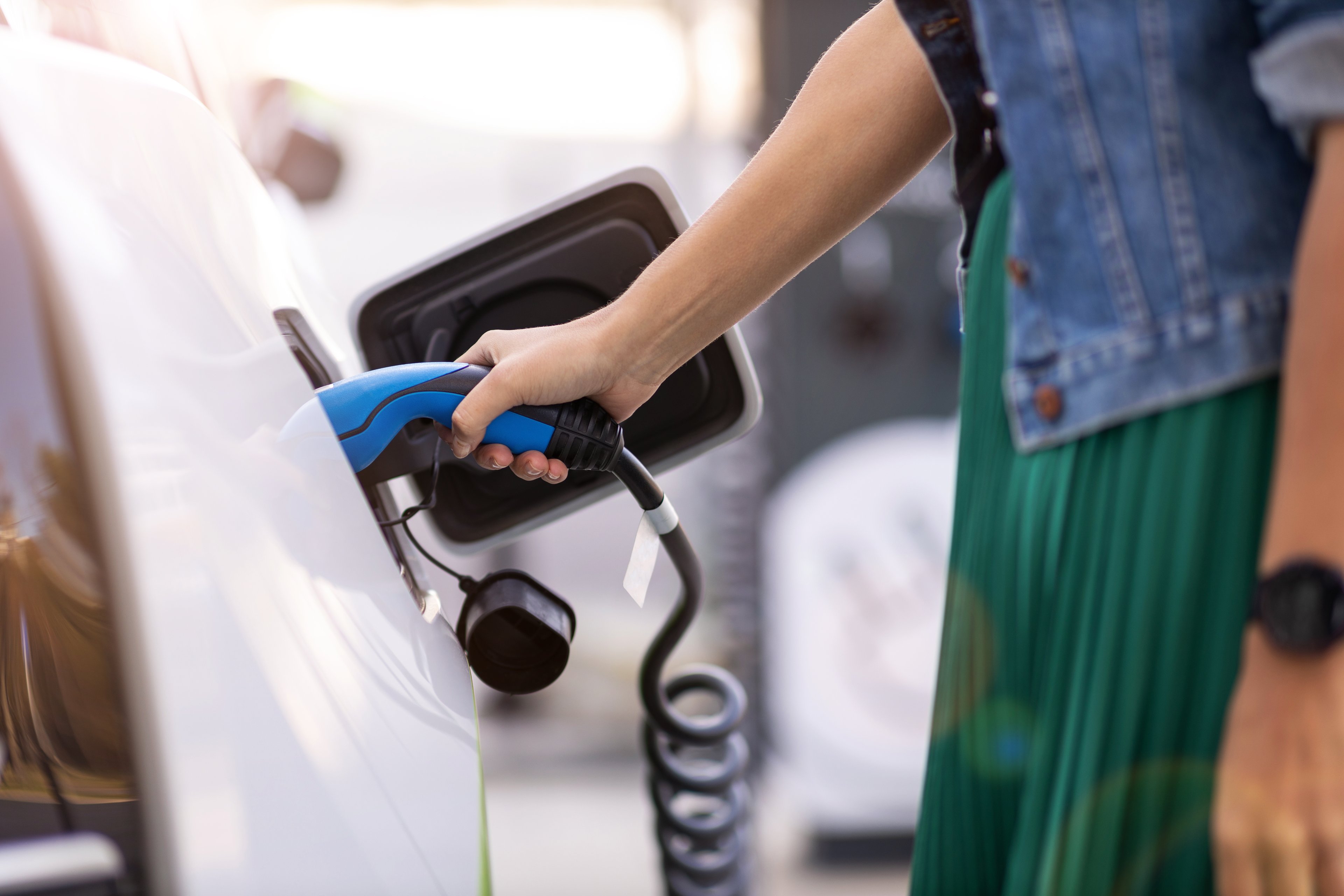 Woman charging her electric car.