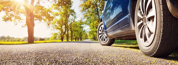 A car heading down a gravel road.