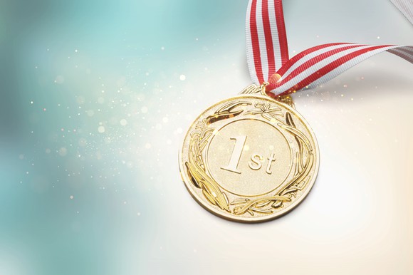 A gold medal reads 1st