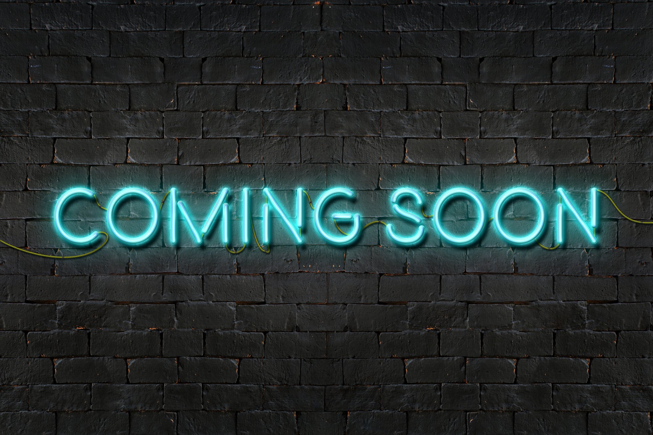 A neon sign that says coming soon