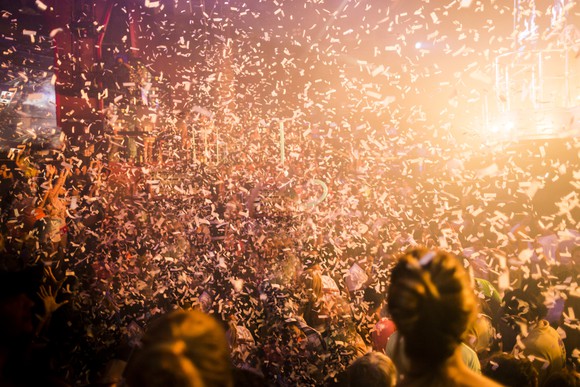 Confetti falling at a packed arena.