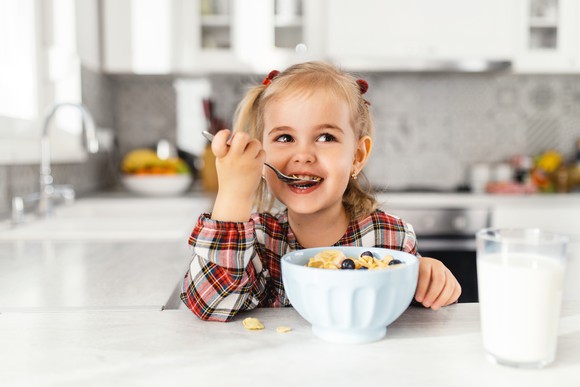 A child eating a bowl of cereal.