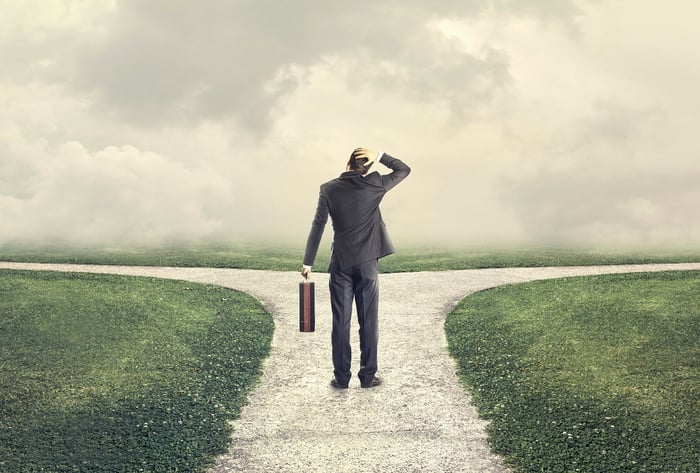 Man standing at fork in the road.