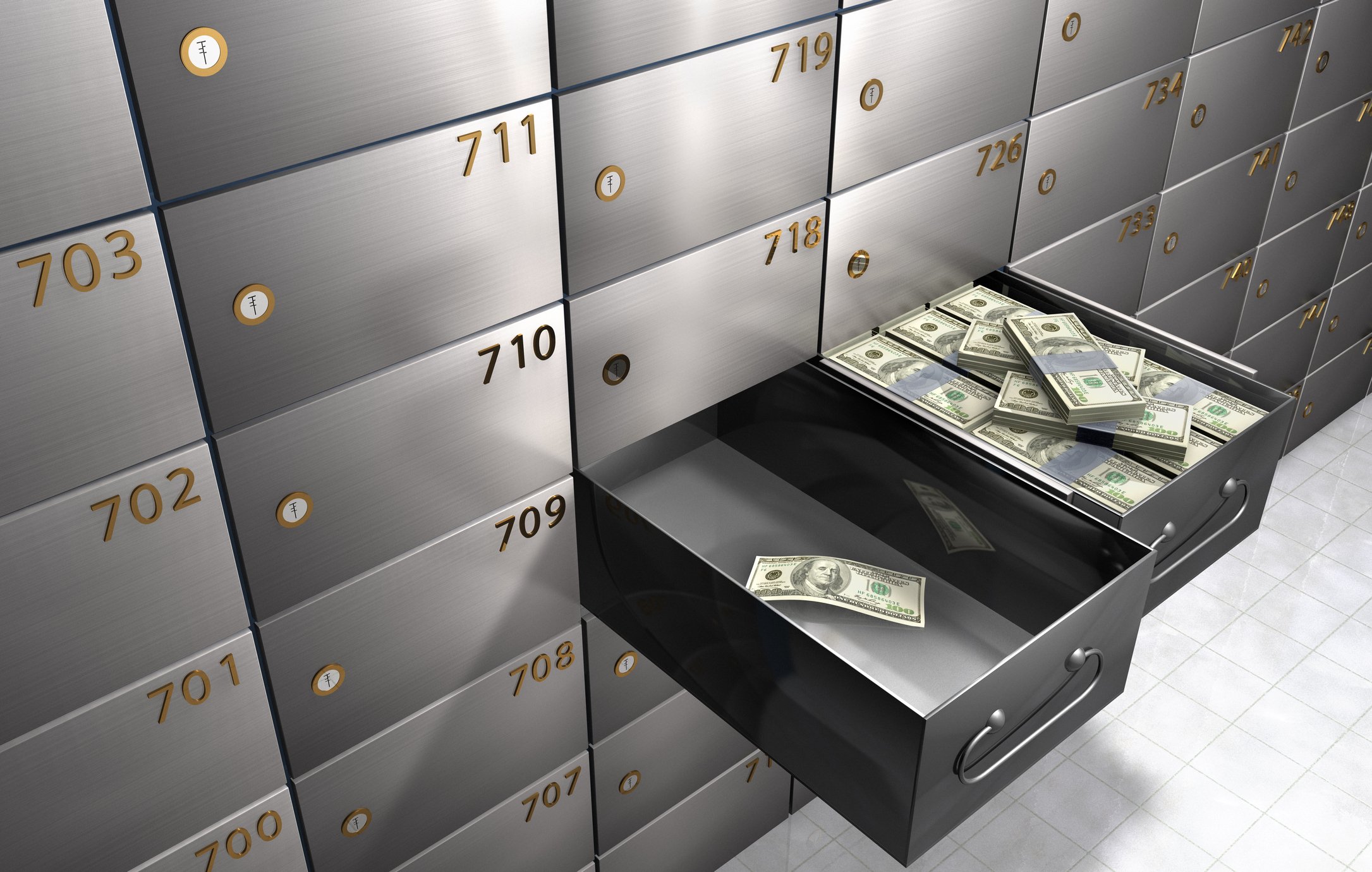 two safe deposit boxes with different levels of cash