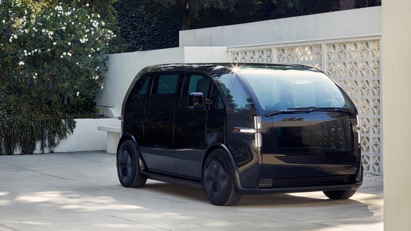 A black Canoo electric minivan.