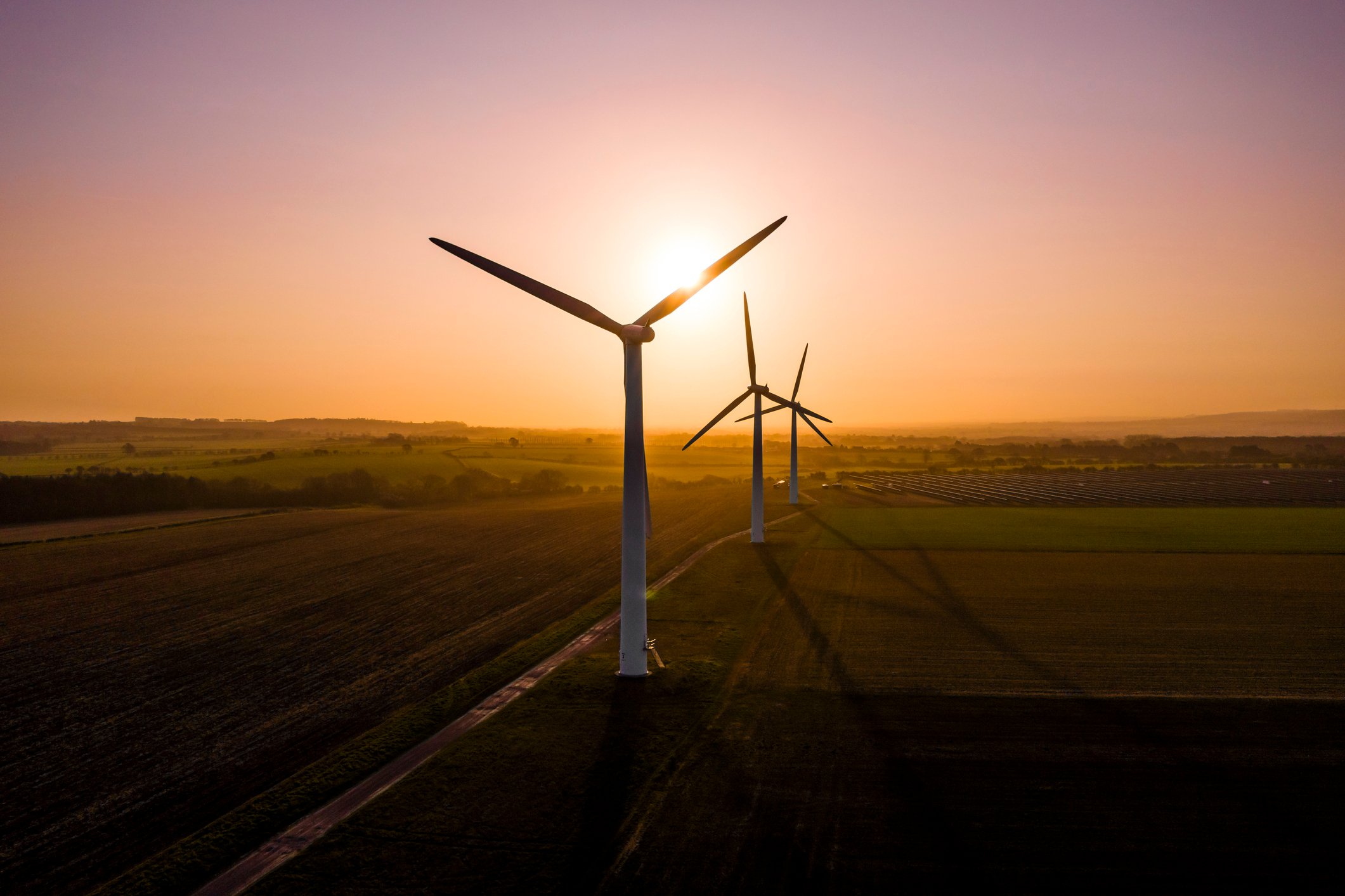 Three wind turbines at sunrise. 