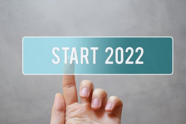 Hand touches a button that reads Start 2022