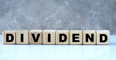 DIVIDEND written in wooden blocks