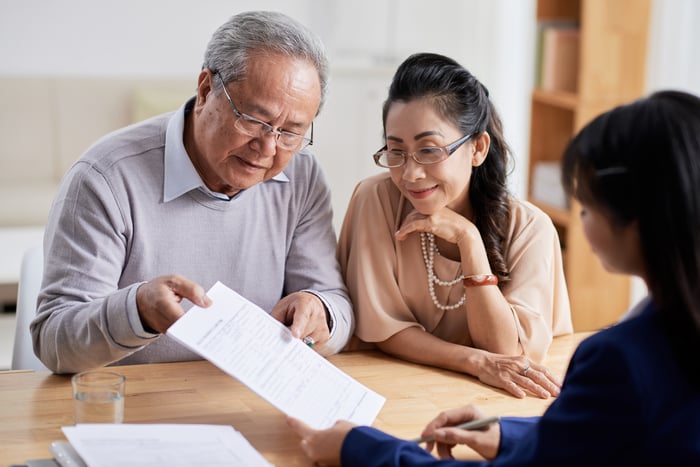 A pair of older adults consider a retirment portfolio.