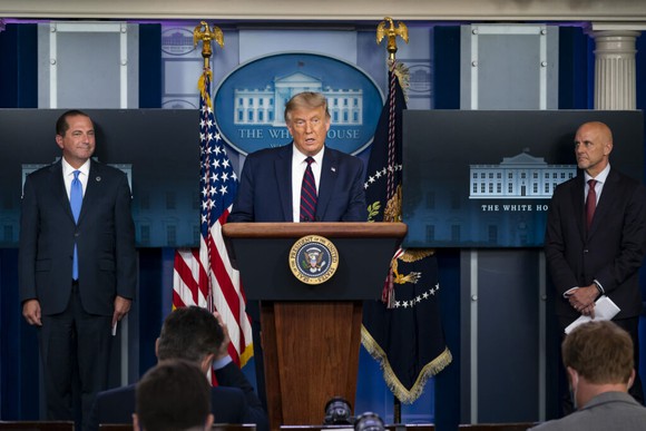 President Trump behind a podium at a news conference.  