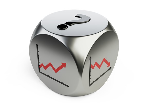 Silver die with question mark on top side, chart trending up on one side, and chart trending down on another side